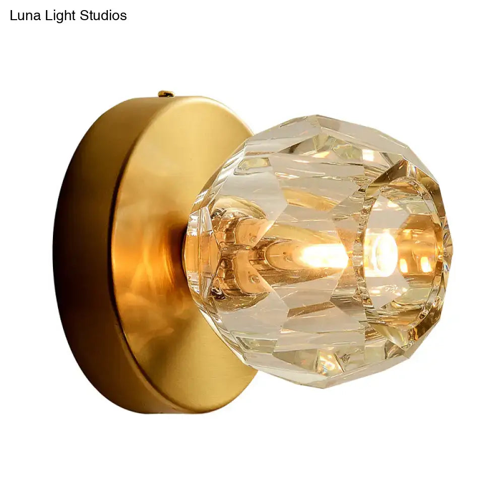 Contemporary golden wall mount lamp with faceted glass shade living room