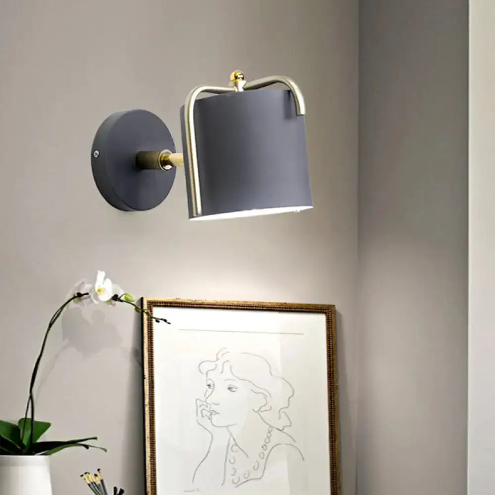 Contemporary green & grey sconce with brass accents for bedroom