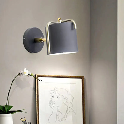 Contemporary green & grey sconce with brass accents for bedroom