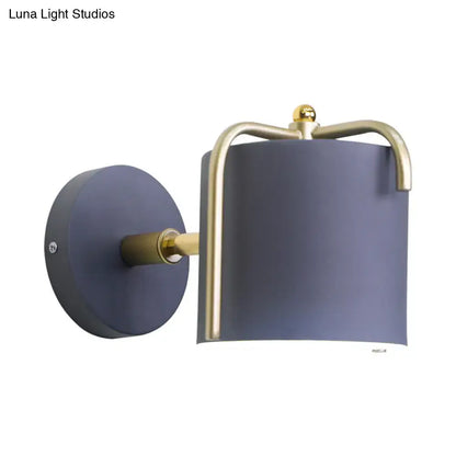 Contemporary green & grey sconce with brass accents for bedroom