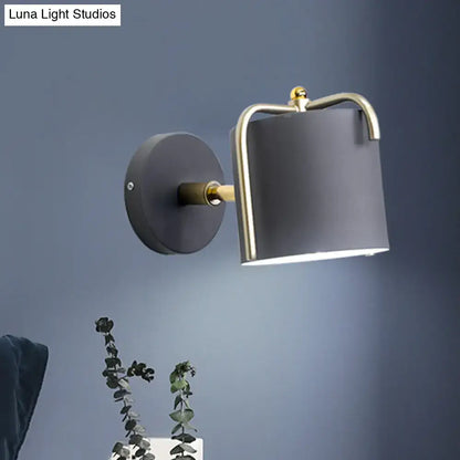 Contemporary green & grey sconce with brass accents for bedroom
