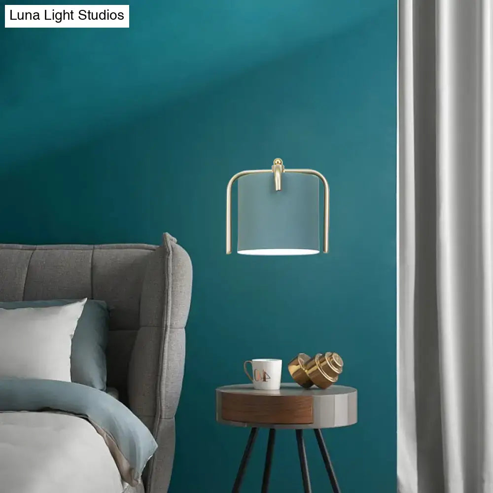 Contemporary green & grey sconce with brass accents for bedroom