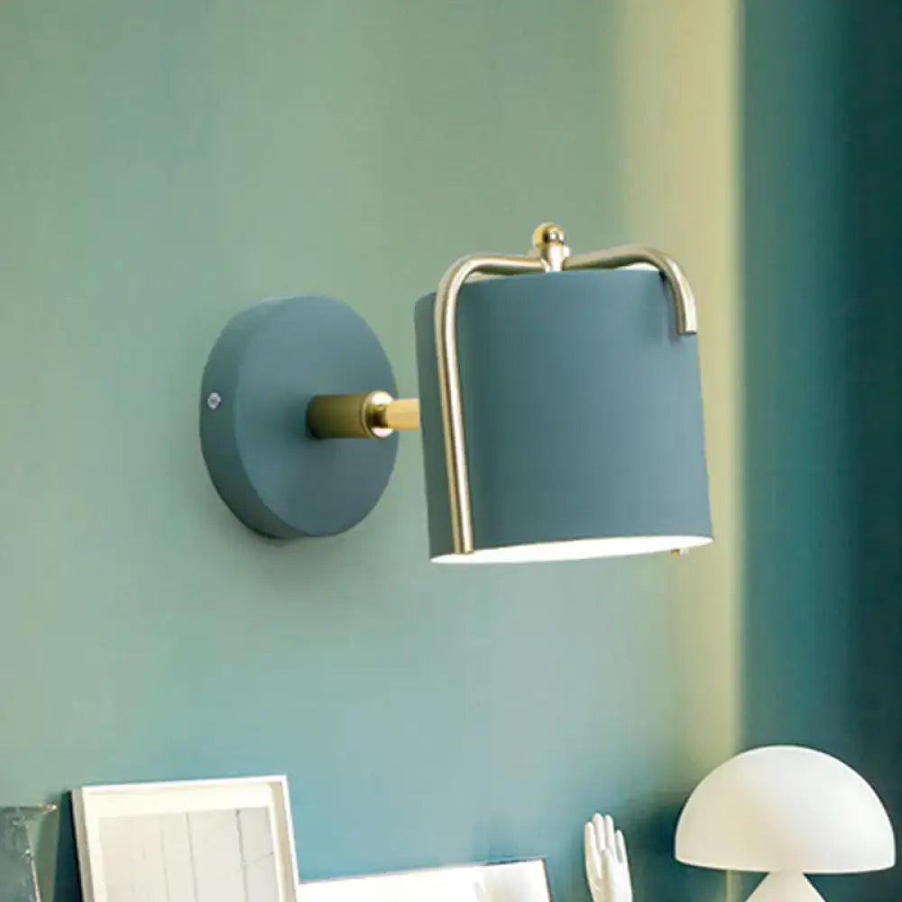 Contemporary green & grey sconce with brass accents for bedroom