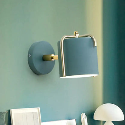 Contemporary green & grey sconce with brass accents for bedroom