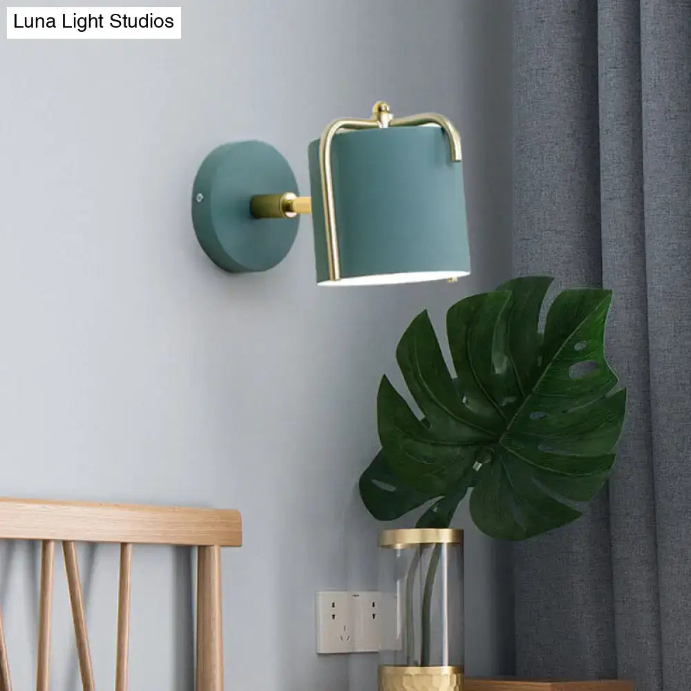 Contemporary green & grey sconce with brass accents for bedroom