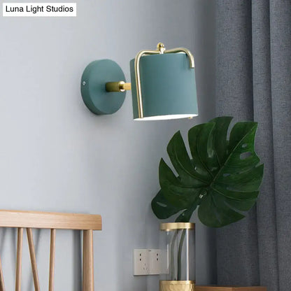 Contemporary green & grey sconce with brass accents for bedroom