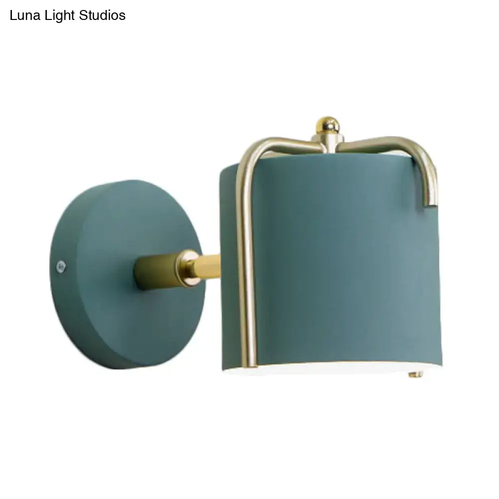 Contemporary green & grey sconce with brass accents for bedroom