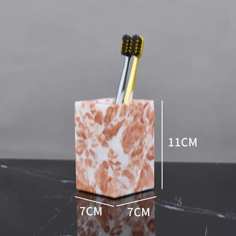 Coral pink marble bathroom accessories set with gold accents