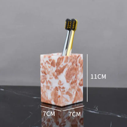 Coral pink marble bathroom accessories set with gold accents