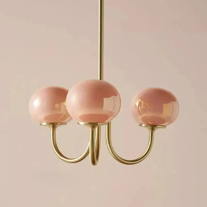 Cream pink bedroom pendant light with three glass globes and brass