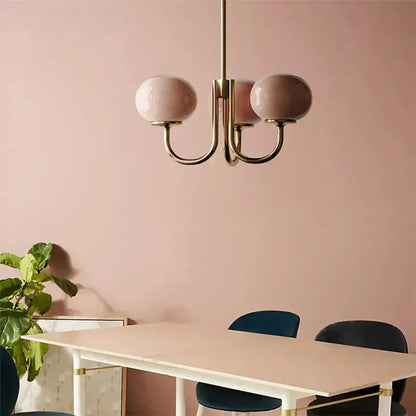 Cream pink bedroom pendant light with three glass globes and brass