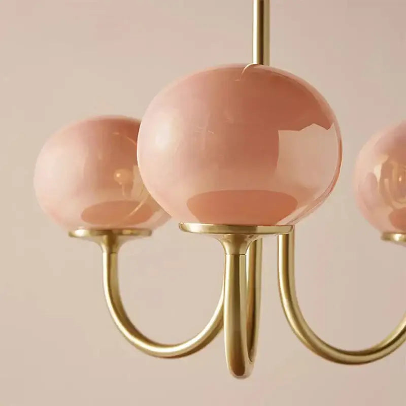 Cream pink bedroom pendant light with three glass globes and brass
