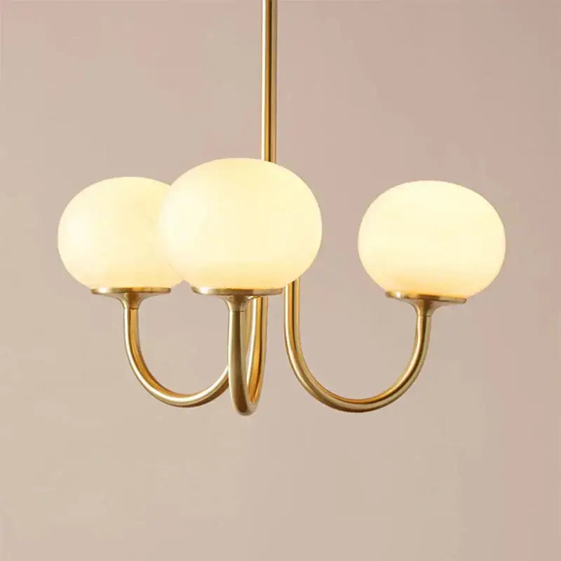 Cream pink bedroom pendant light with three glass globes and brass