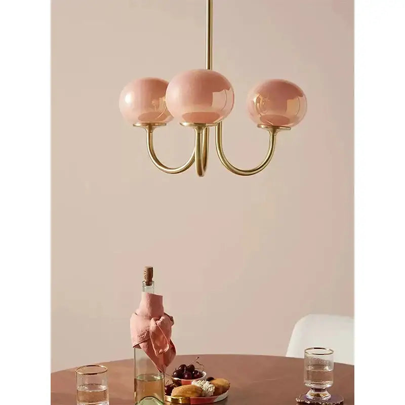 Cream pink bedroom pendant light with three glass globes and brass