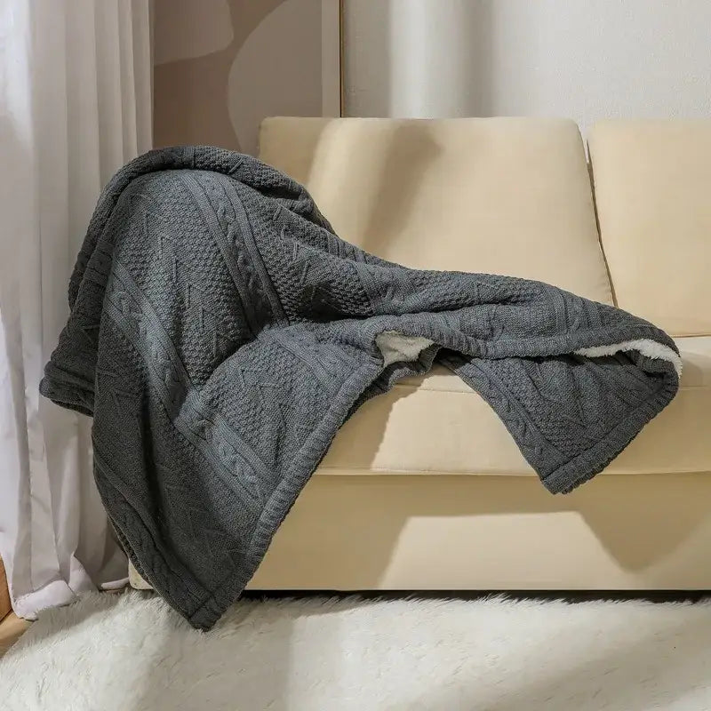 Dark gray fishbone knit blanket with white fleece lining living room