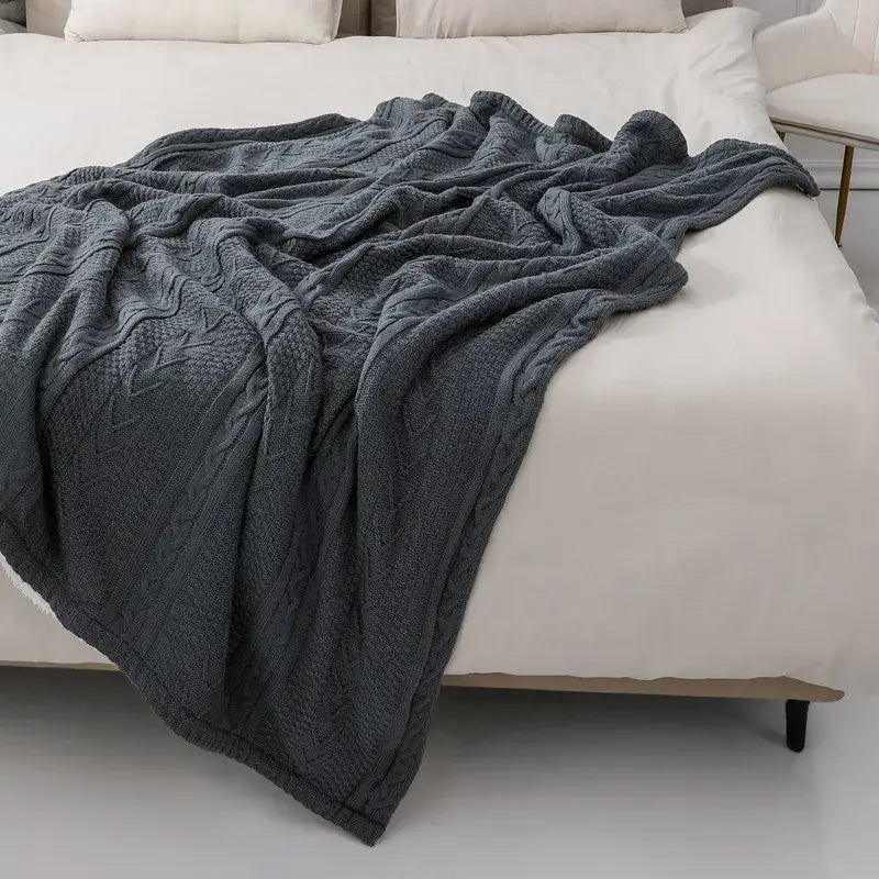Dark gray fishbone knit blanket with white fleece lining living room