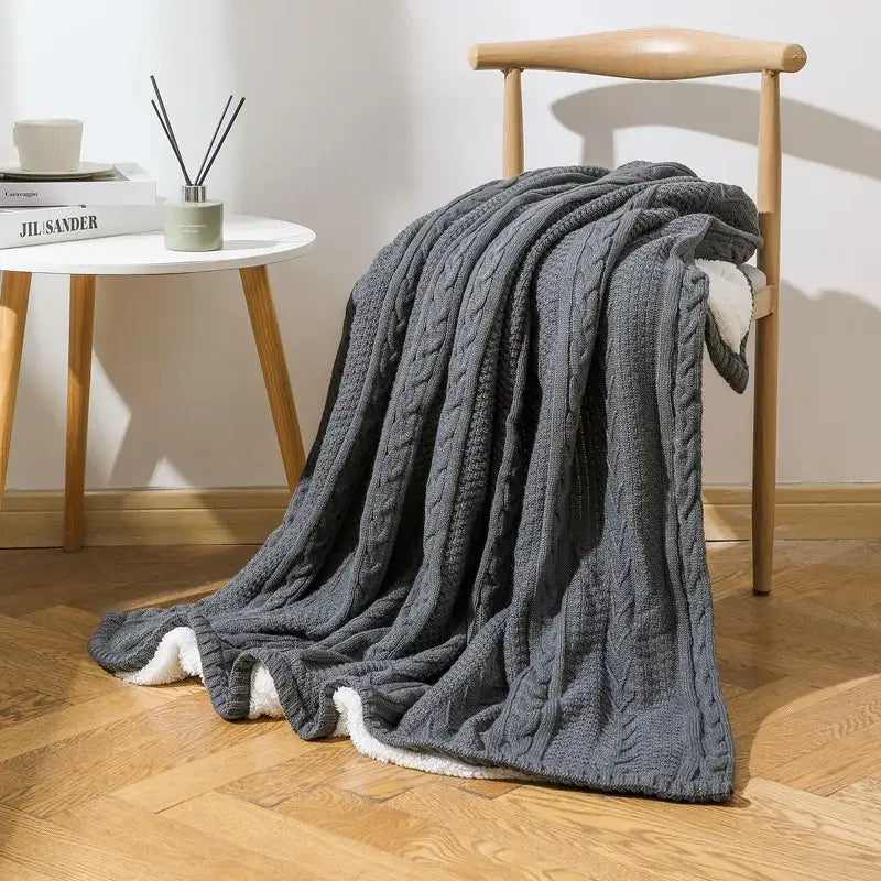 Dark gray fishbone knit blanket with white fleece lining living room
