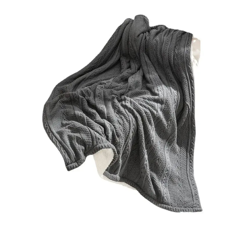Dark gray fishbone knit blanket with white fleece lining living room