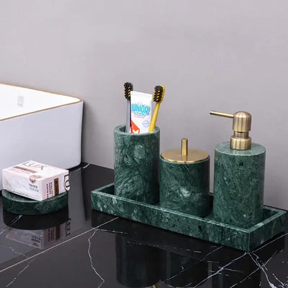 Dark green marble bathroom accessory set with gold accents