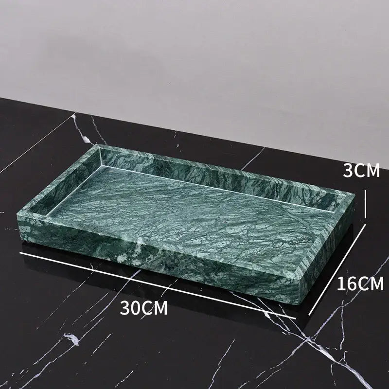Dark green marble bathroom accessory set with gold accents