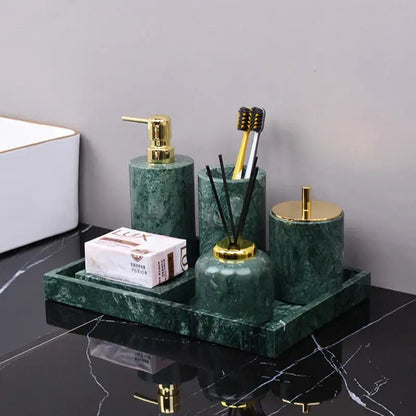 Dark green marble bathroom accessory set with gold accents