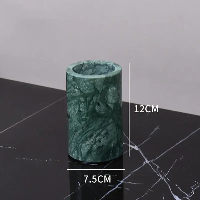 Dark green marble bathroom accessory set with gold accents