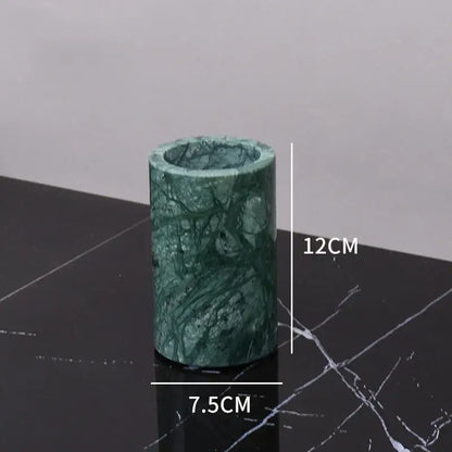 Dark green marble bathroom accessory set with gold accents