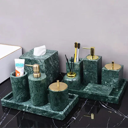 Dark green marble bathroom accessory set with gold accents