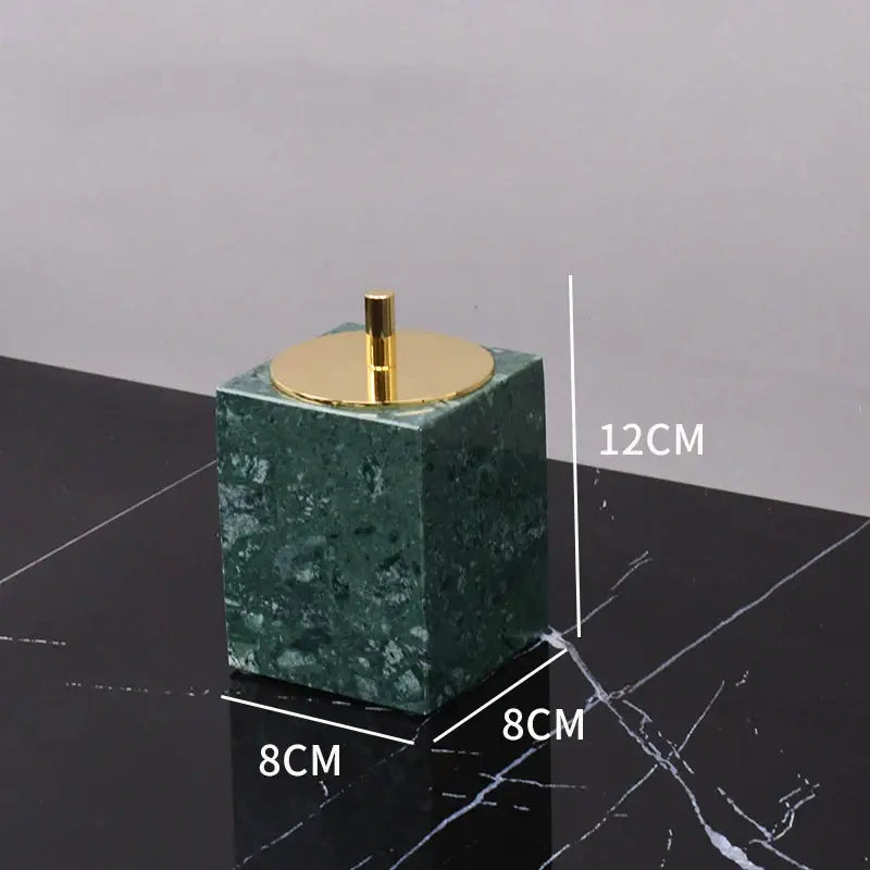Dark green marble bathroom accessory set with gold accents