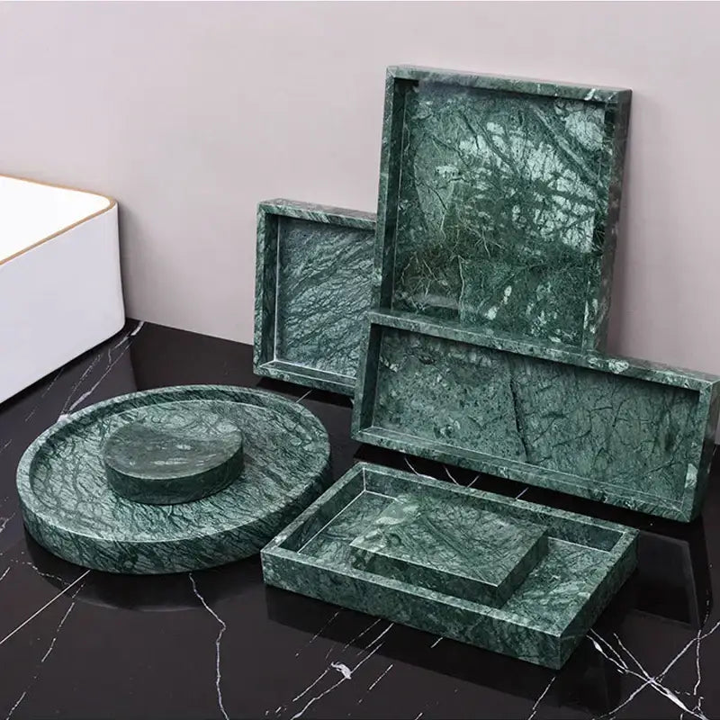 Dark green marble bathroom accessory set with gold accents