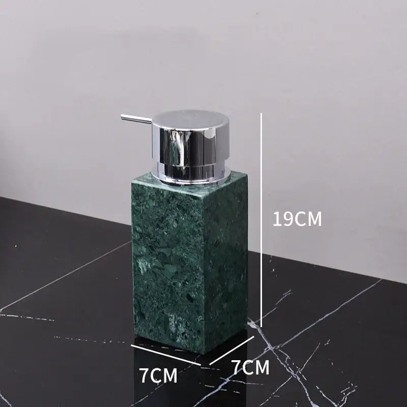 Dark green marble bathroom accessory set with gold accents