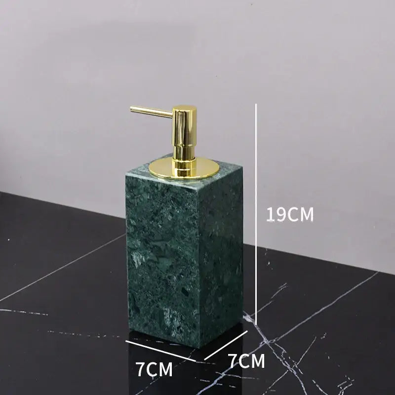 Dark green marble bathroom accessory set with gold accents