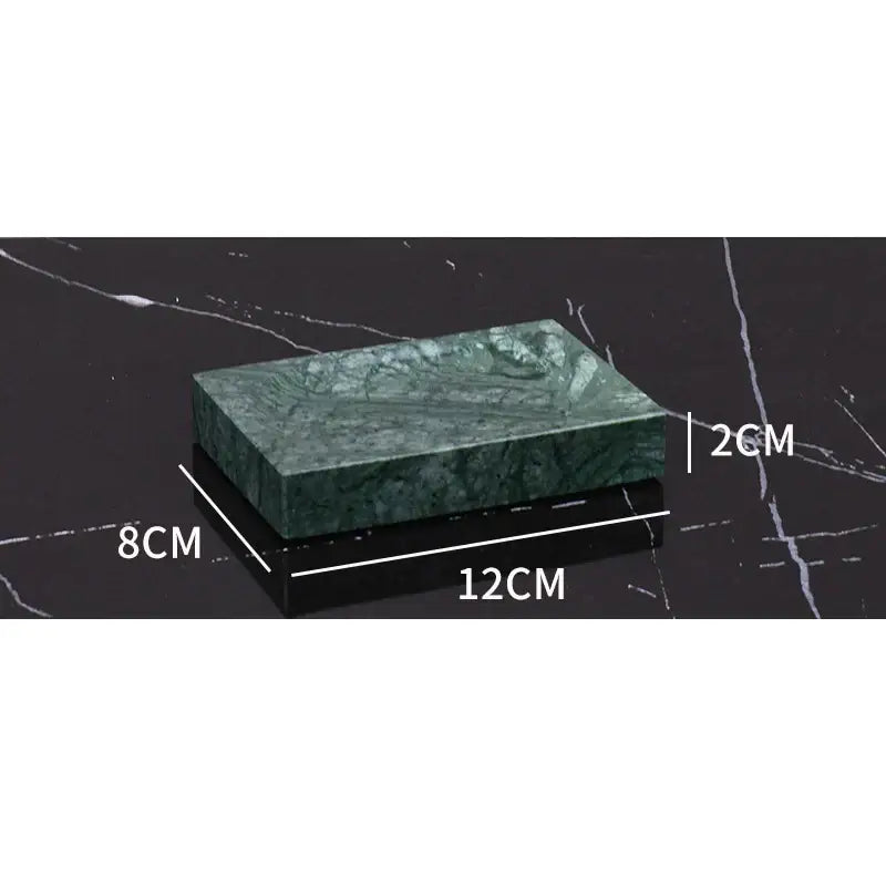 Dark green marble bathroom accessory set with gold accents
