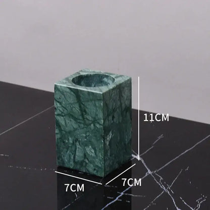 Dark green marble bathroom accessory set with gold accents