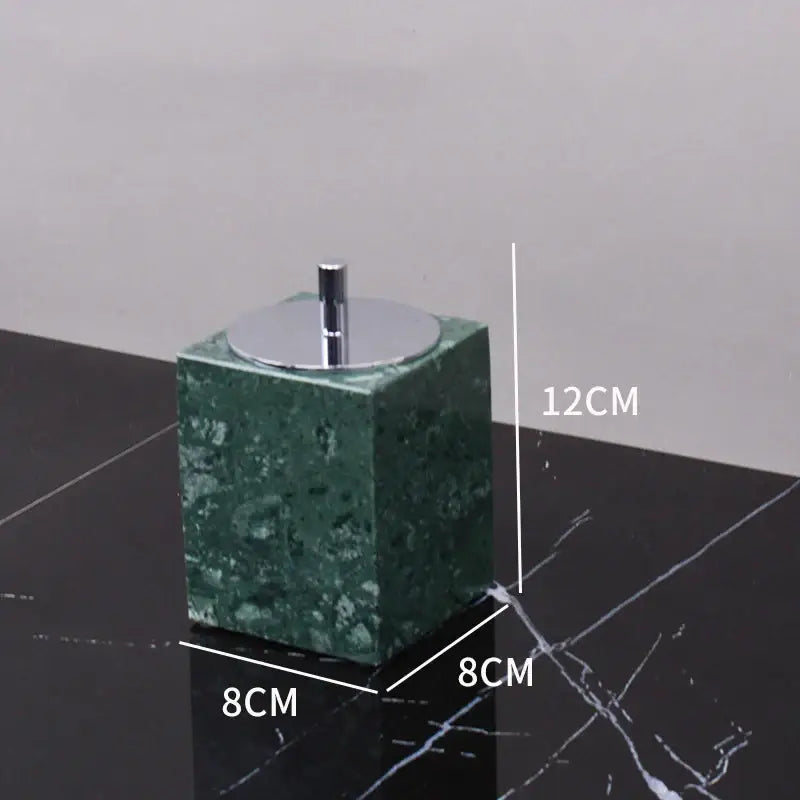 Dark green marble bathroom accessory set with gold accents