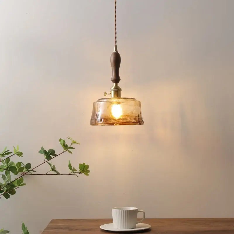 Modern amber glass pendant light with wood handle dining room