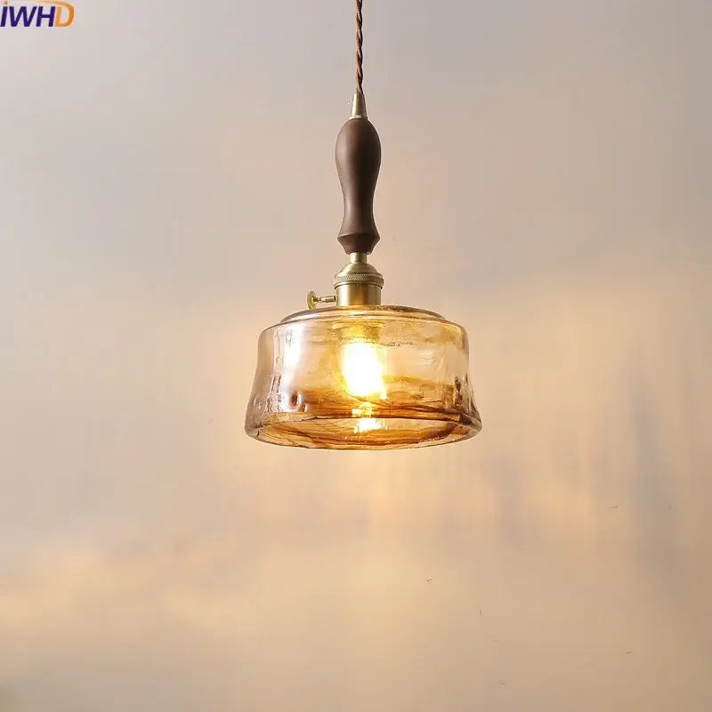 Modern amber glass pendant light with wood handle dining room