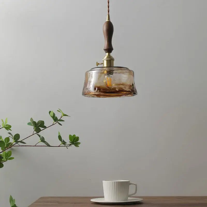 Modern amber glass pendant light with wood handle dining room
