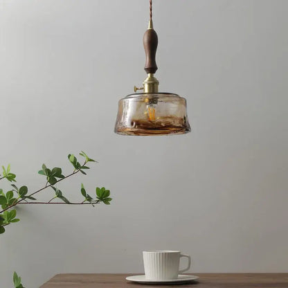 Modern amber glass pendant light with wood handle dining room
