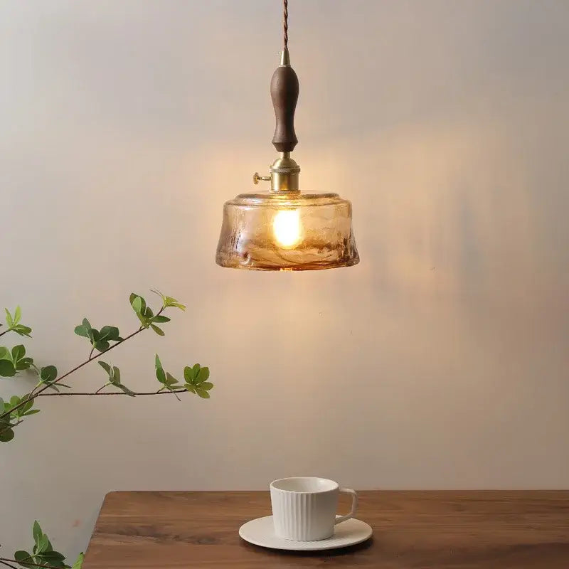 Modern amber glass pendant light with wood handle dining room