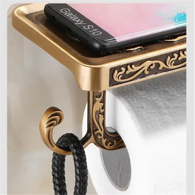 Antique brass ornate toilet paper holder with phone shelf bathroom