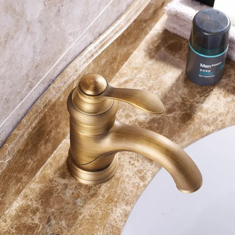 Antique brass basin faucet with curved spout for bathroom sinks
