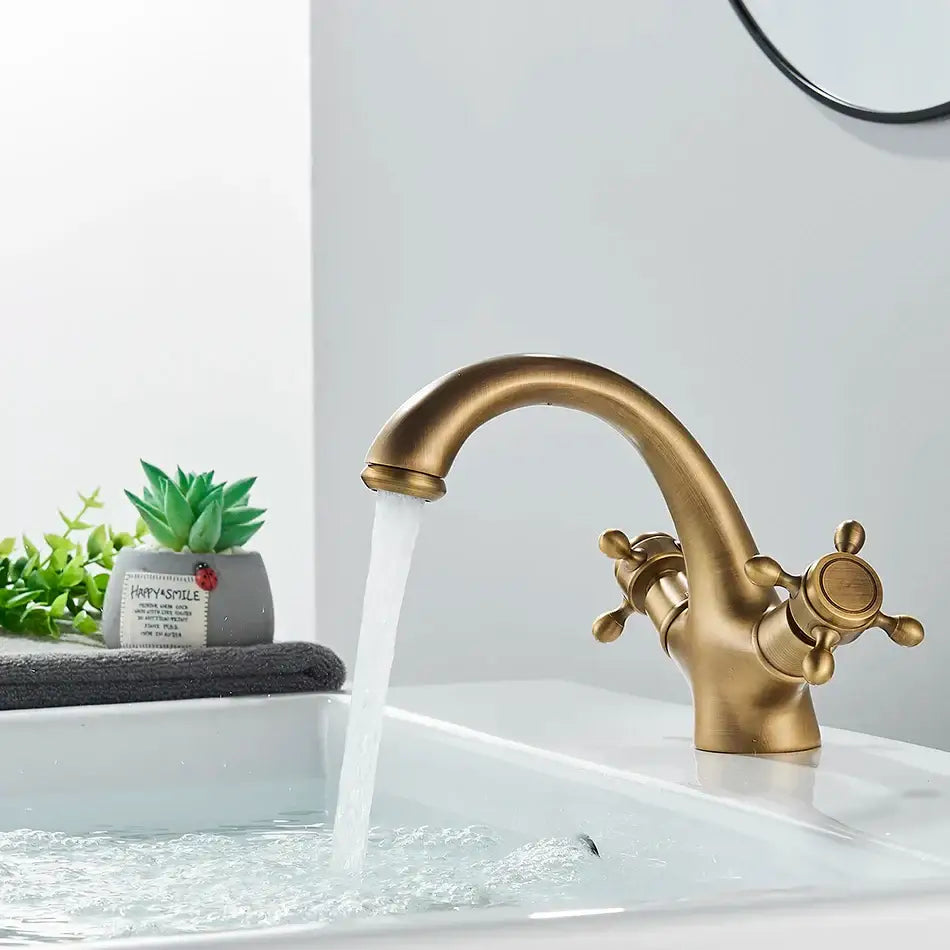 Antique brass basin faucet with ornate cross handles for bathroom