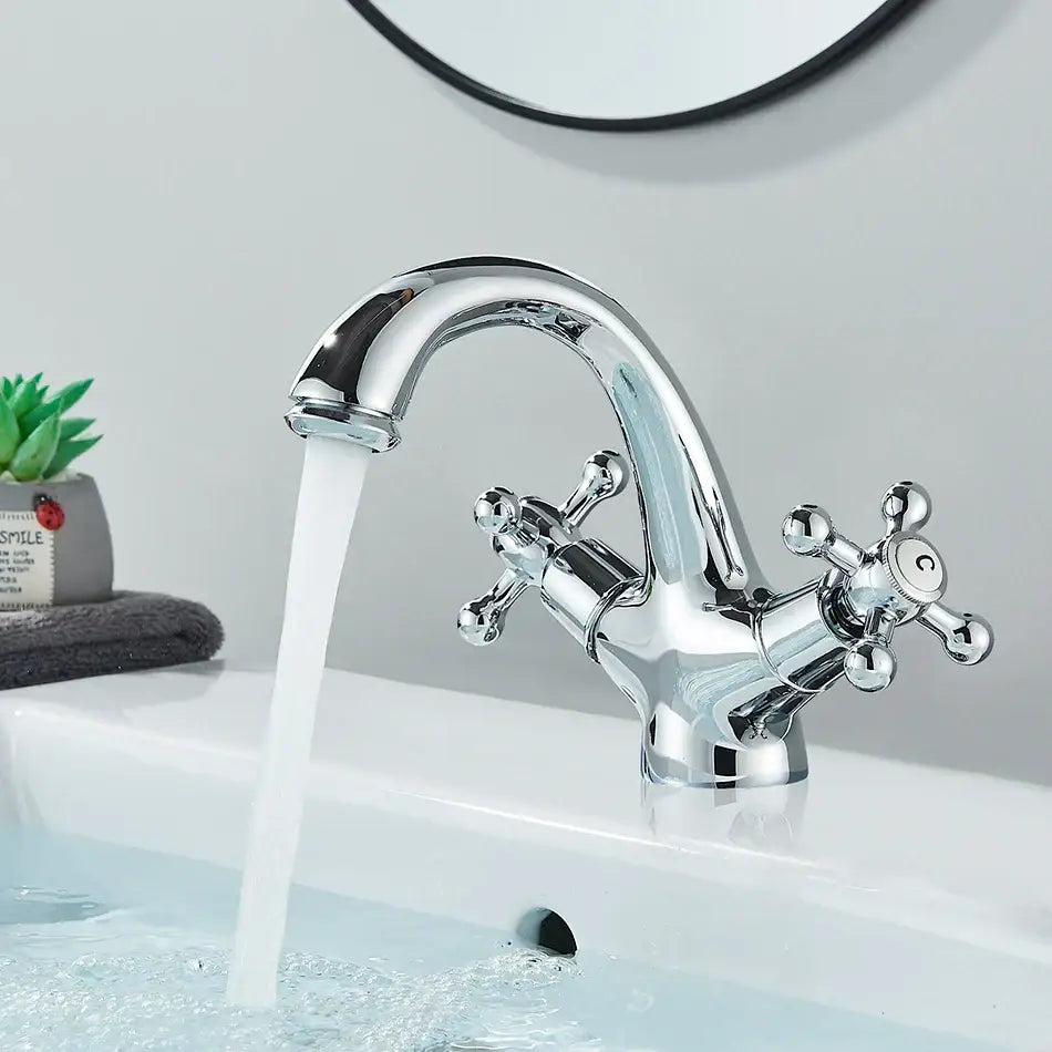Antique brass basin faucet with ornate cross handles for bathroom