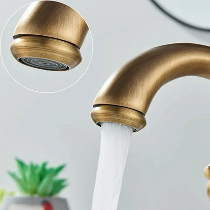 Antique brass basin faucet with ornate cross handles for bathroom