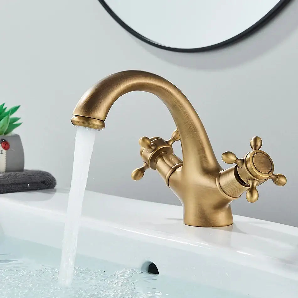 Antique brass basin faucet with ornate cross handles for bathroom