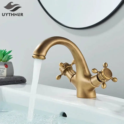 Antique brass basin faucet with ornate cross handles for bathroom