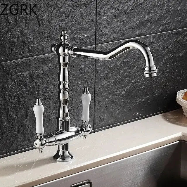 Antique brass kitchen faucet with ceramic handles and curved spout