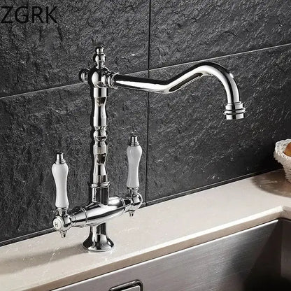 Antique brass kitchen faucet with ceramic handles and curved spout