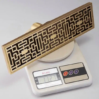 Antique brass linear shower floor drain with carved cover for bathroom